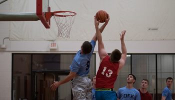 Adults playing basketball