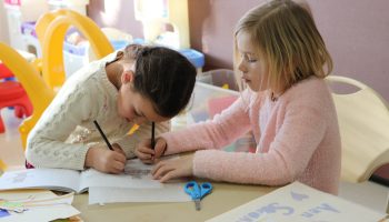 children drawing and coloring together