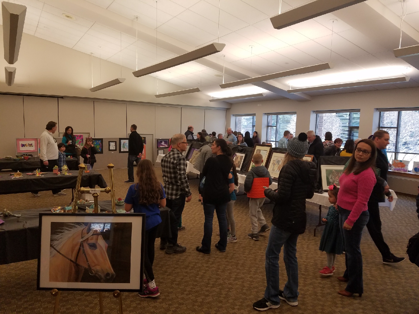 guests looking at artwork at the art show