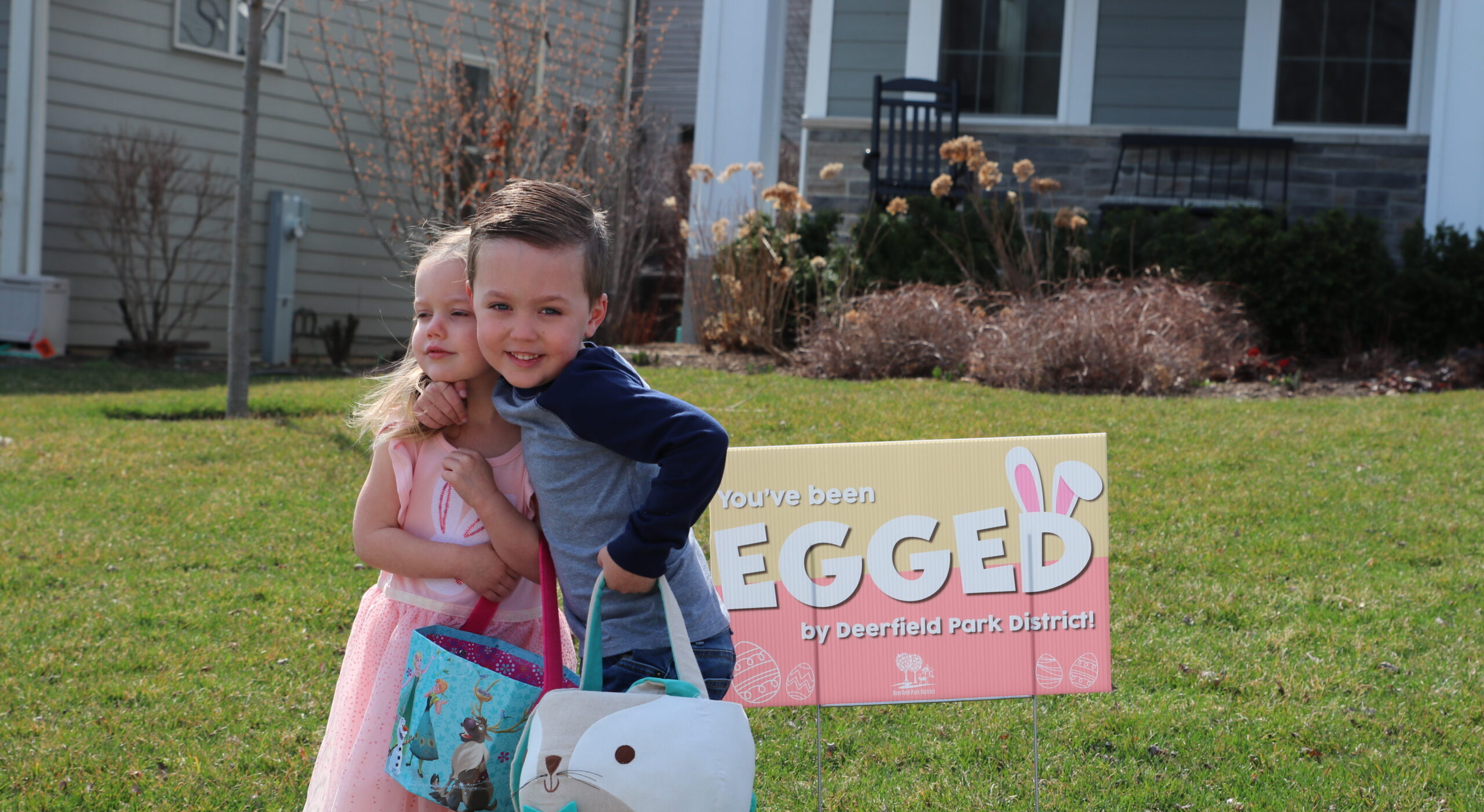 2 kids with Youve Been Egged Sign