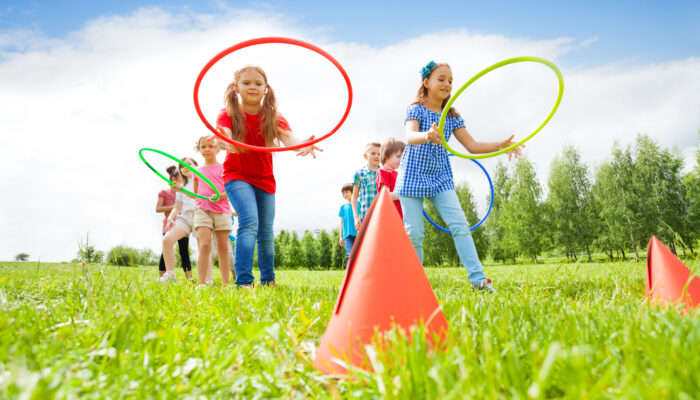 Kids throwing hula hoops in game