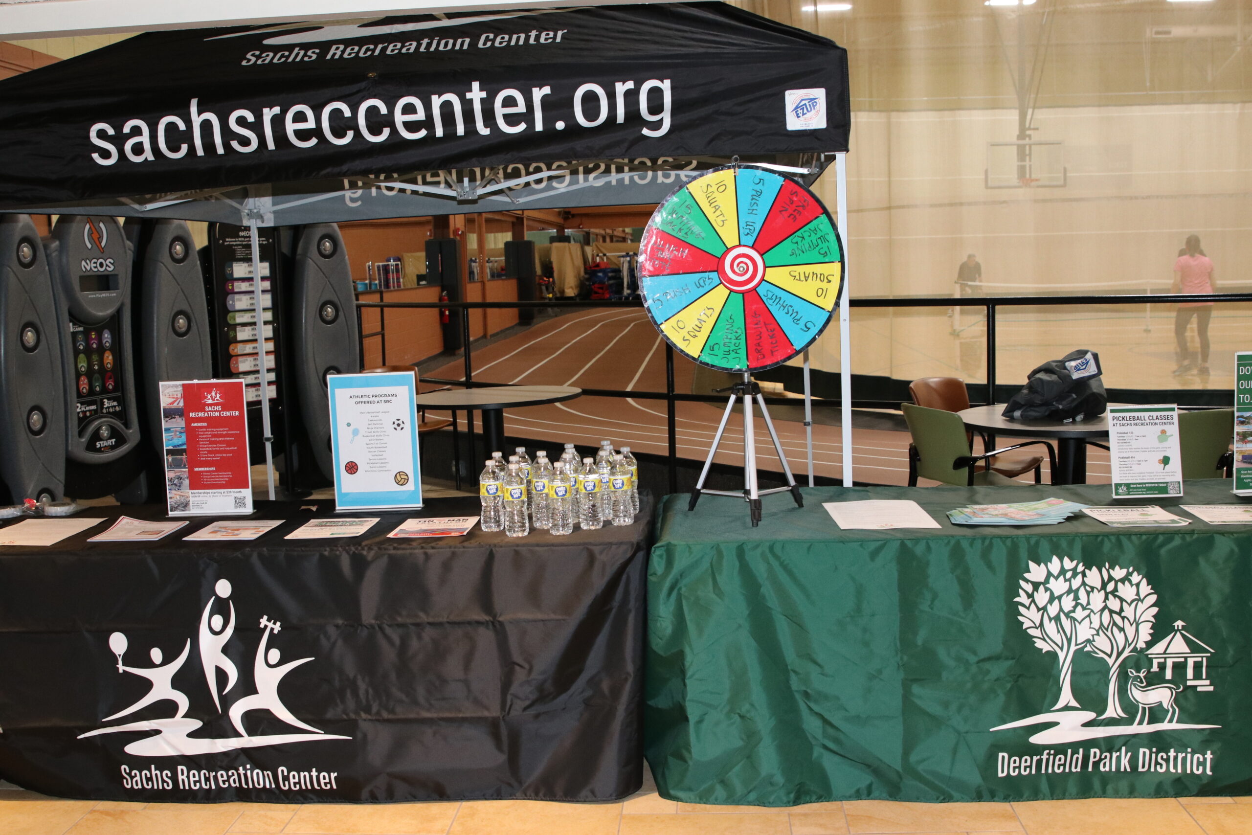 table with Sachs Recreation Center tablecloth under a Sachs recreation center tent