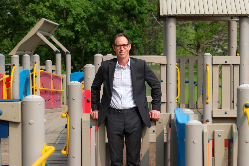 New Executive Director Jeff Harvey standing at Jewett Park Playground